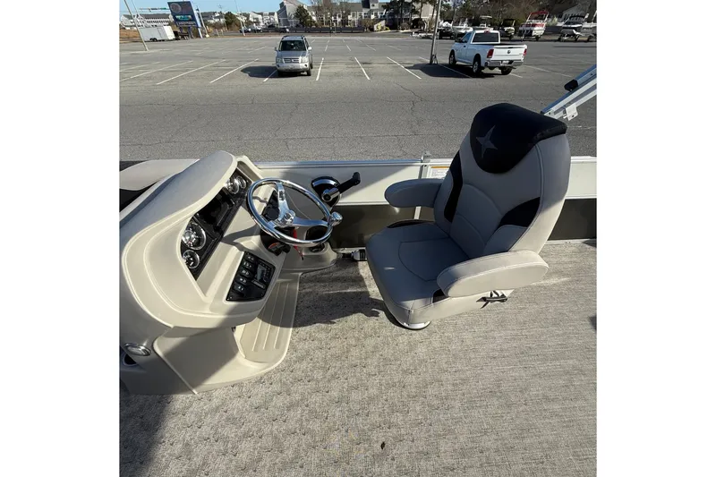 Slide: The Image of 2025 Berkshire 24CL 2.75 LE boat interior with steering wheel and captain's chair. - 13