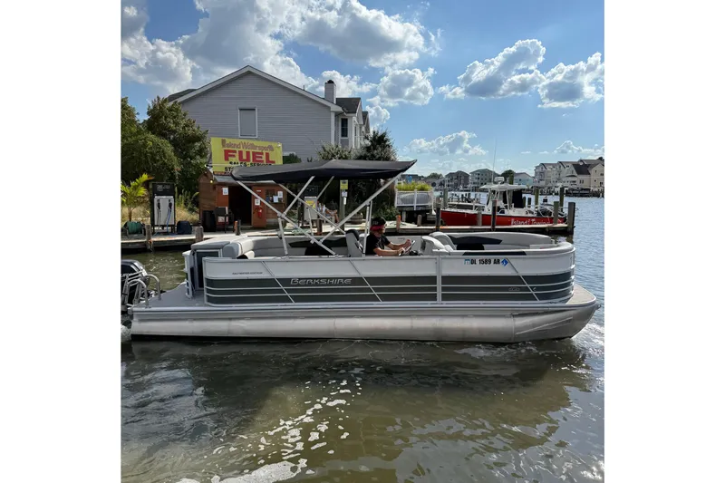 Slide: The Image of 2025 Berkshire 24CL 2.75 LE pontoon boat for sale, parked in a marina. - 3