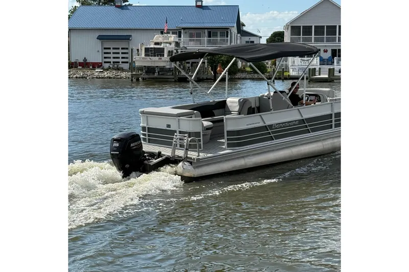 Slide: The Image of 2025 Berkshire 24CL 2.75 LE pontoon boat with canopy, parked outdoors. - 4