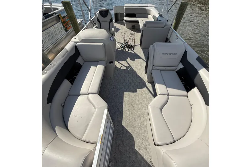 Slide: The Image of 2025 Berkshire 24CL 2.75 LE pontoon boat parked under a clear blue sky. - 5