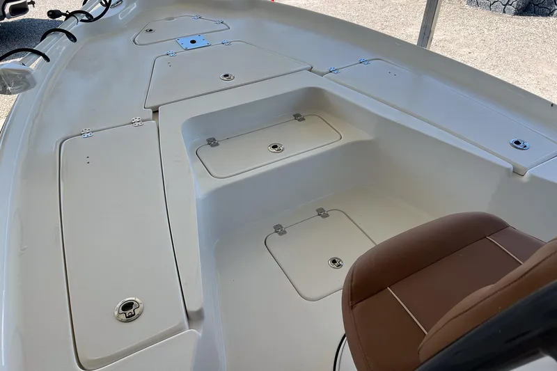 Slide: The Image of 2026 Key West 230 Bay Reef boat interior with storage compartments and seating. - 14