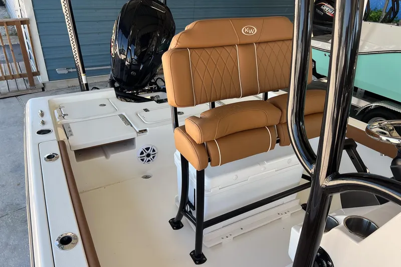 Slide: The Image of 2026 Key West 230 Bay Reef boat interior with tan seating and modern design. - 19