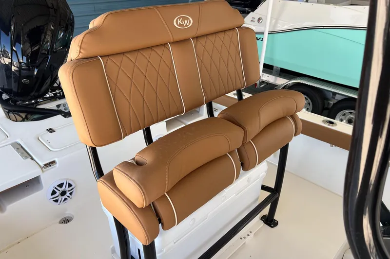 Slide: The Image of 2026 Key West 230 Bay Reef boat seat with tan leather upholstery and white accents. - 20