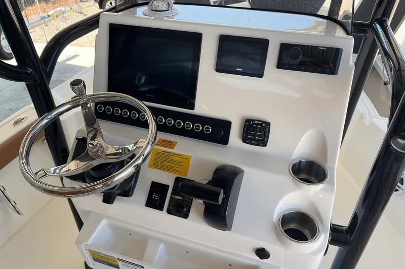 Slide: The Image of 2026 Key West 230 Bay Reef boat console with steering wheel and electronic displays. - 21