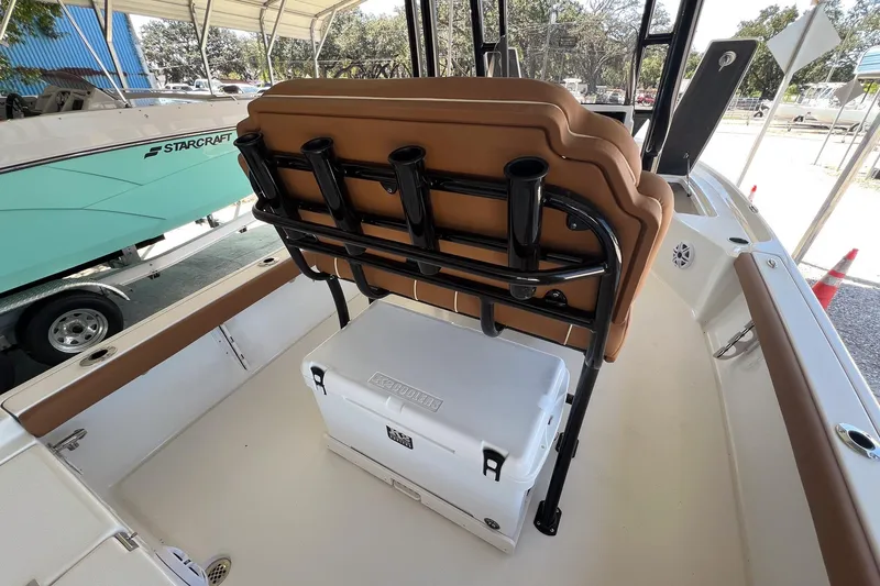 Slide: The Image of 2026 Key West 230 Bay Reef boat interior with seating and cooler storage. - 25