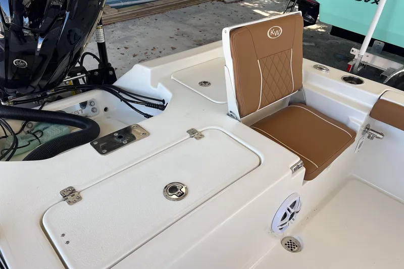 Slide: The Image of 2026 Key West 230 Bay Reef boat interior with tan seating and storage compartments. - 31