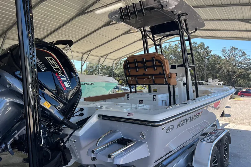 Slide: The Image of 2026 Key West 230 Bay Reef boat with Yamaha engine in covered storage. - 5