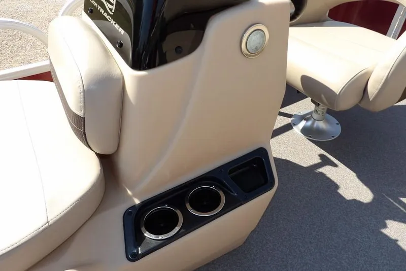 Slide: The Image of 2018 Sun Tracker BASS BUGGY® 18 DLX boat interior with beige seating and cup holders. - 14