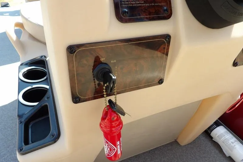 Slide: The Image of 2018 Sun Tracker BASS BUGGY® 18 DLX ignition panel with keys and cup holders. - 15