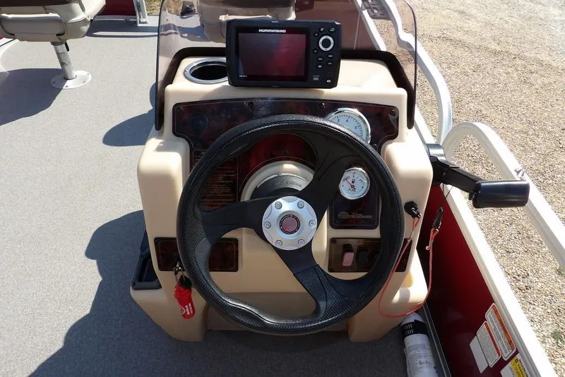 Slide: The Image of 2018 Sun Tracker BASS BUGGY® 18 DLX boat dashboard with steering wheel and navigation system. - 17