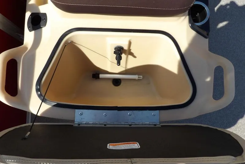 Slide: The Image of 2018 Sun Tracker BASS BUGGY® 18 DLX storage compartment with open lid and cup holders. - 19