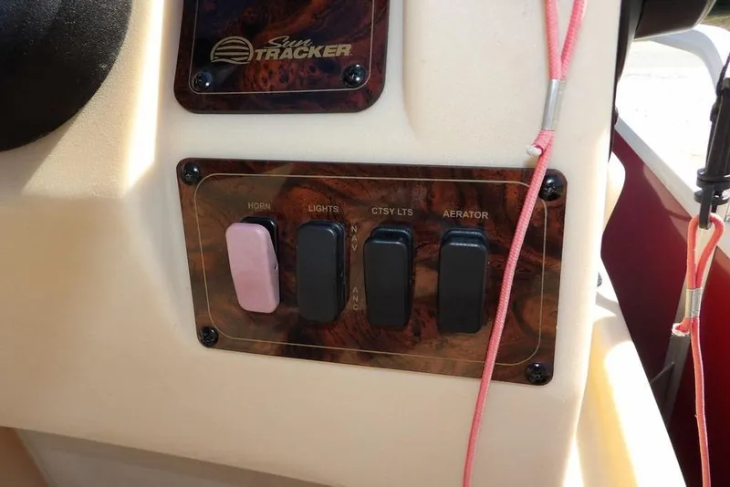 Slide: The Image of Control panel of 2018 Sun Tracker BASS BUGGY® 18 DLX with switches for horn, lights, and aerator. - 21