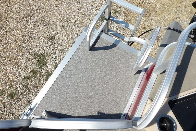 Slide: The Image of 2018 Sun Tracker BASS BUGGY® 18 DLX boat deck with aluminum ladder and carpeted surface. - 28