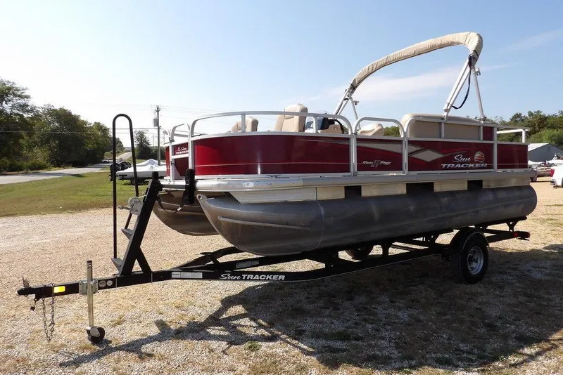 Slide: The Image of 2018 Sun Tracker BASS BUGGY® 18 DLX pontoon boat on trailer, parked outdoors. - 3