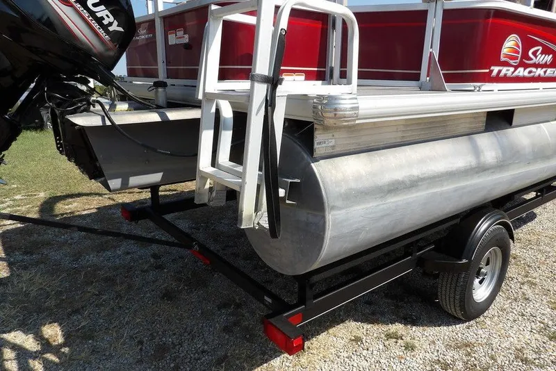 Slide: The Image of 2018 Sun Tracker BASS BUGGY® 18 DLX pontoon boat on trailer, featuring Mercury outboard motor. - 32