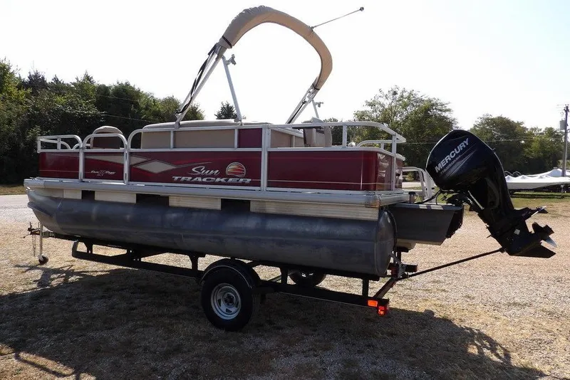 Slide: The Image of 2018 Sun Tracker BASS BUGGY® 18 DLX pontoon boat on trailer, with Mercury outboard motor. - 4