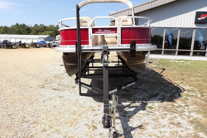 Slide: The Image of 2018 Sun Tracker BASS BUGGY® 18 DLX pontoon boat on trailer, parked outdoors. - 5