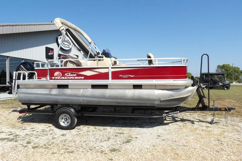 Slide: The Image of 2018 Sun Tracker BASS BUGGY® 18 DLX pontoon boat on trailer, parked outdoors. - 6