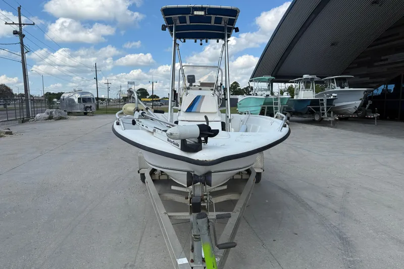 Slide: The Image of 2005 Sea Chaser 1800 RG boat on trailer, parked outdoors under a blue sky. - 3