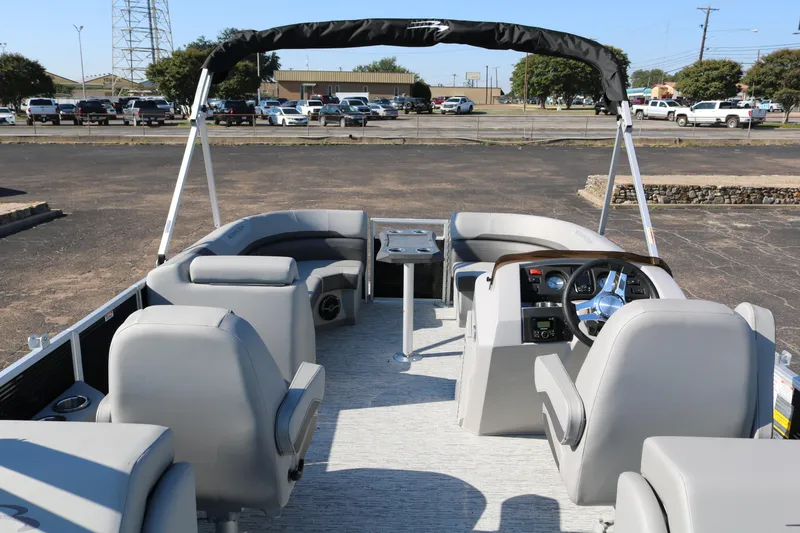 Slide: The Image of 2026 Bennington 22SX Stern Radius pontoon boat interior with seating and steering console. - 11