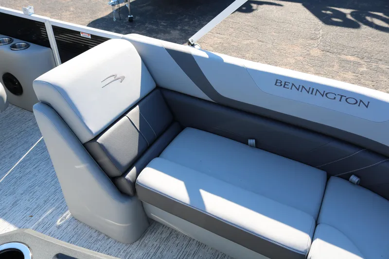 Slide: The Image of 2026 Bennington 22SX Stern Radius boat interior with gray seating and logo. - 13