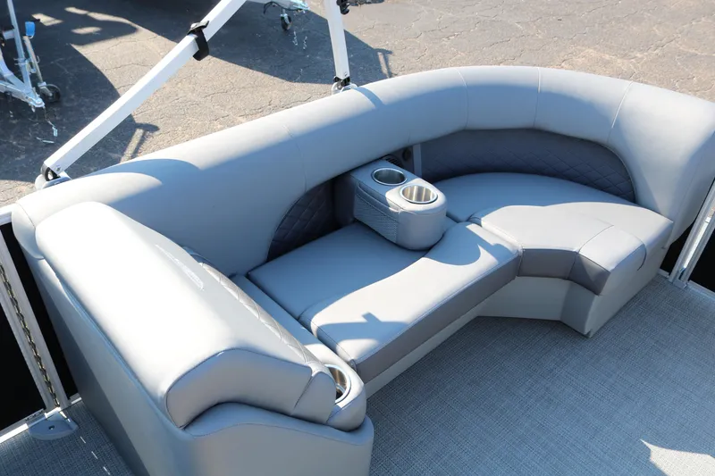 Slide: The Image of 2026 Bennington 22SX Stern Radius boat interior with curved seating and cup holder. - 21