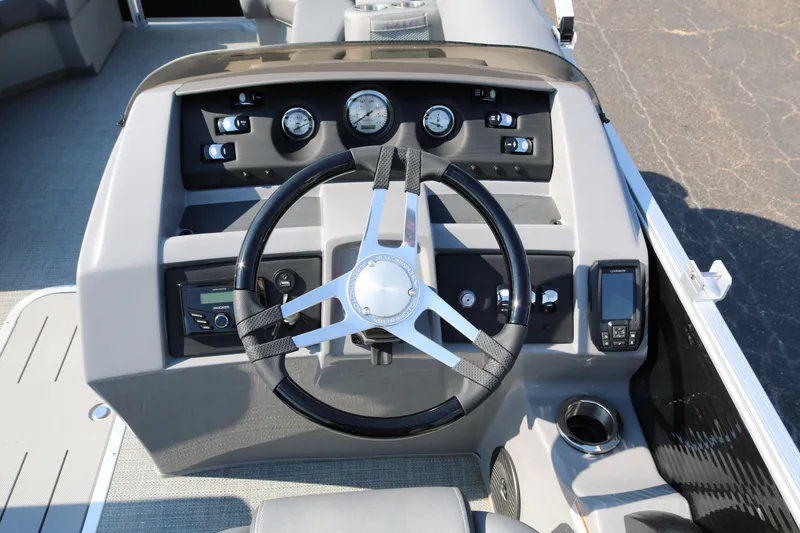 Slide: The Image of 2026 Bennington 22SX Stern Radius boat with open storage compartment and cushioned seating. - 34