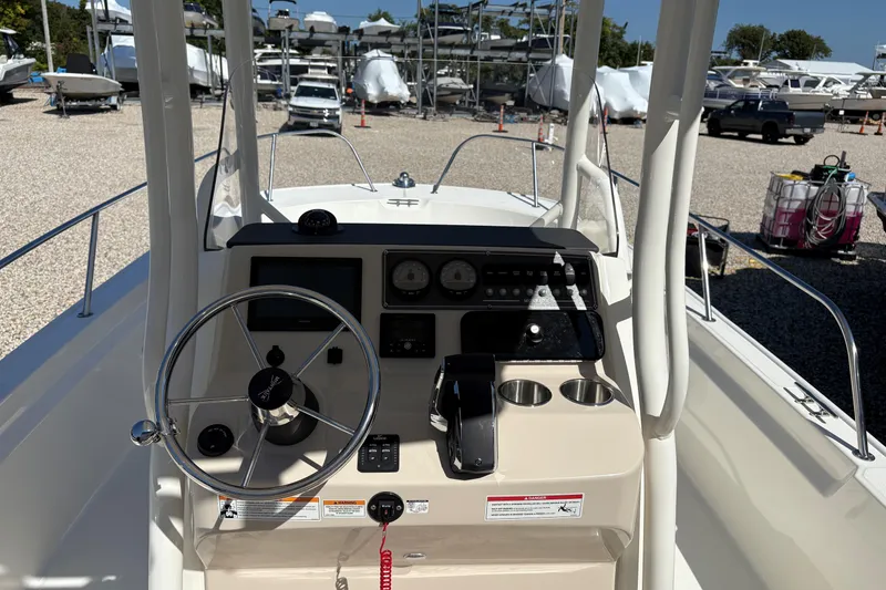 Slide: The Image of 2024 Boston Whaler 210 Montauk boat console with steering wheel and controls. - 10