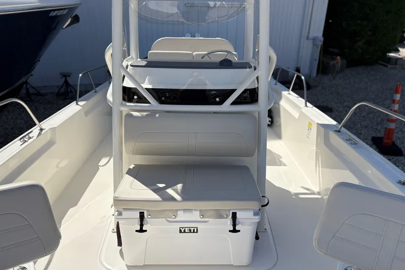Slide: The Image of 2024 Boston Whaler 210 Montauk boat interior with Yeti cooler and seating. - 12