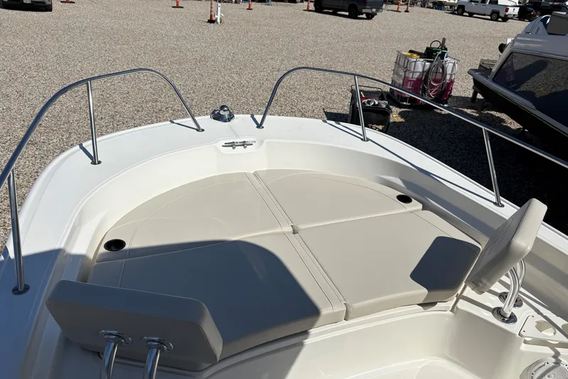Slide: The Image of 2024 Boston Whaler 210 Montauk boat deck with seating and railings. - 13