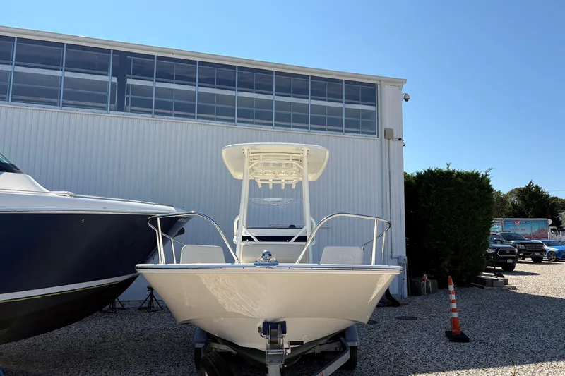 Slide: The Image of 2024 Boston Whaler 210 Montauk boat displayed outdoors near a building. - 14