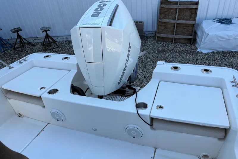 Slide: The Image of 2024 Boston Whaler 210 Montauk boat with Mercury engine, featuring spacious deck layout. - 3