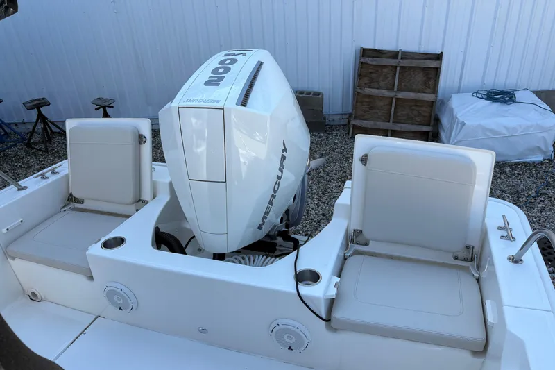 Slide: The Image of 2024 Boston Whaler 210 Montauk boat with Mercury engine and seating area. - 4