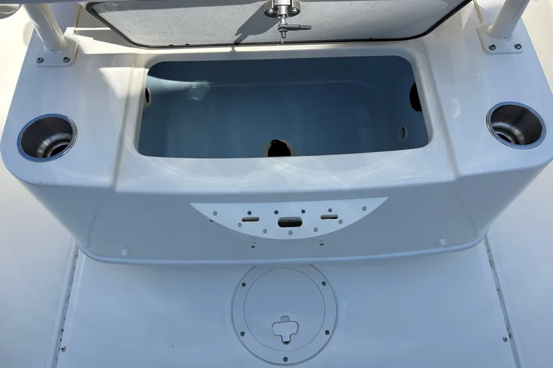 Slide: The Image of 2024 Boston Whaler 210 Montauk boat interior with storage compartment and cup holders. - 6