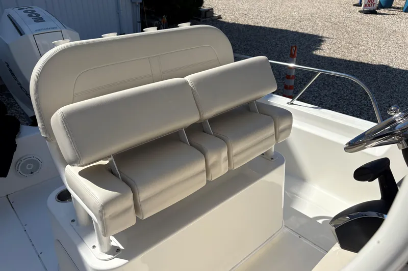 Slide: The Image of 2024 Boston Whaler 210 Montauk boat interior with dual seating and steering wheel. - 8