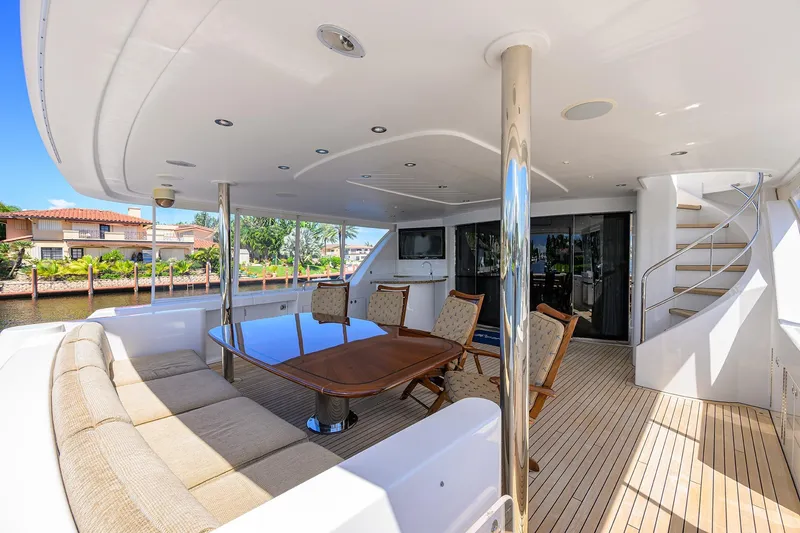 Slide: The Image of Luxurious 2014 Westport 112 yacht deck with elegant seating and dining area. - 2