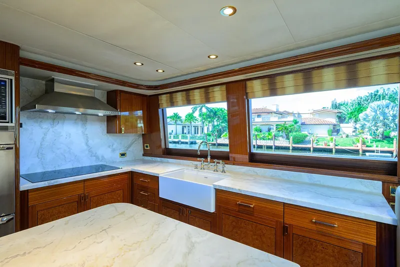 Slide: The Image of Luxurious kitchen interior on 2014 Westport 112 yacht with marble countertops and wooden cabinetry. - 20