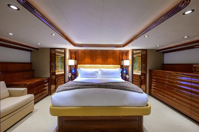 Slide: The Image of Luxurious bedroom interior on 2014 Westport 112 yacht, featuring elegant wood finishes and modern amenities. - 29