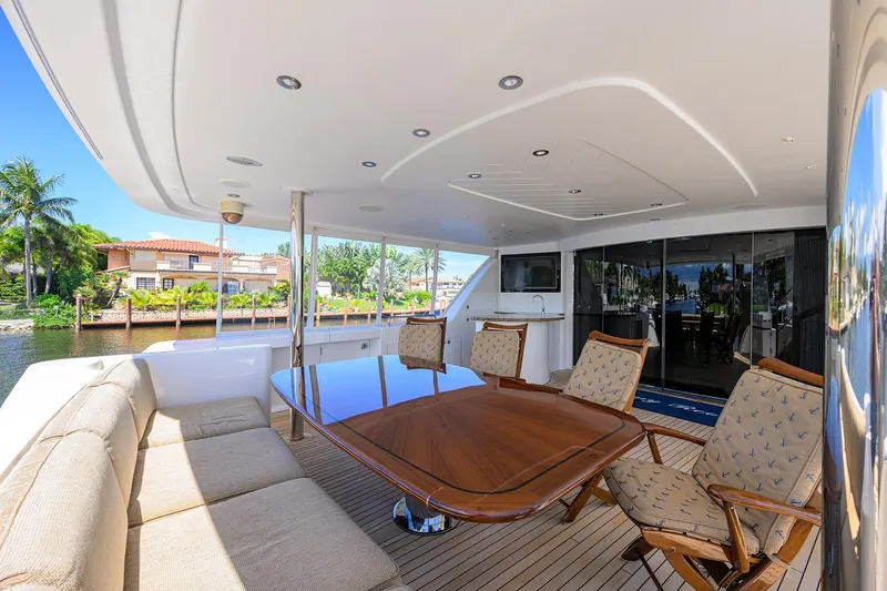 Slide: The Image of Luxurious 2014 Westport 112 yacht deck with elegant seating and waterfront view. - 3