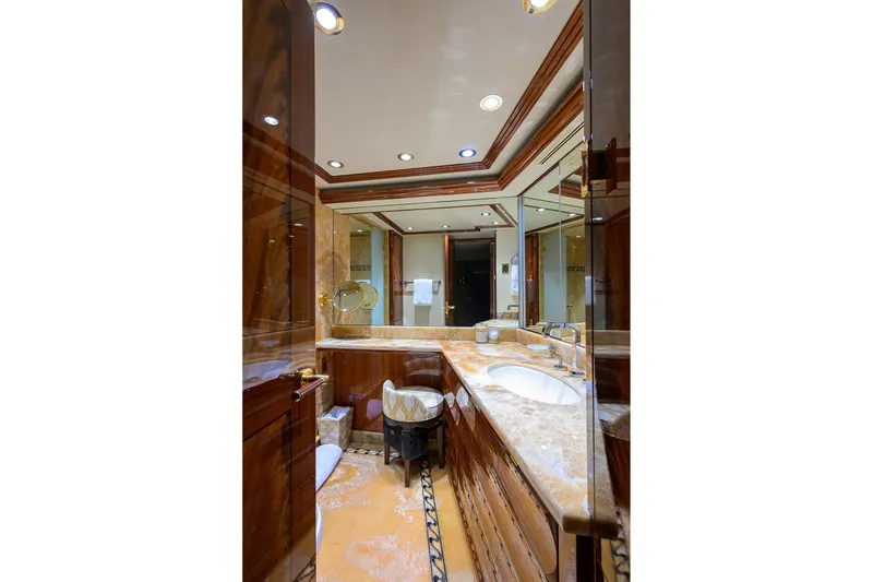 Slide: The Image of Luxurious bathroom in 2014 Westport 112 yacht with marble countertops and elegant wood finishes. - 33