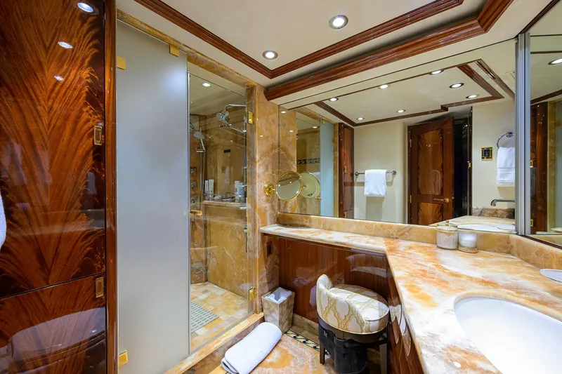 Slide: The Image of Luxurious bathroom interior on 2014 Westport 112 yacht, featuring elegant wood finishes and marble countertops. - 34