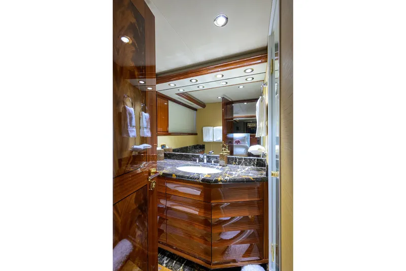 Slide: The Image of Luxurious bathroom in 2014 Westport 112 yacht with marble countertop and glass shower door. - 44