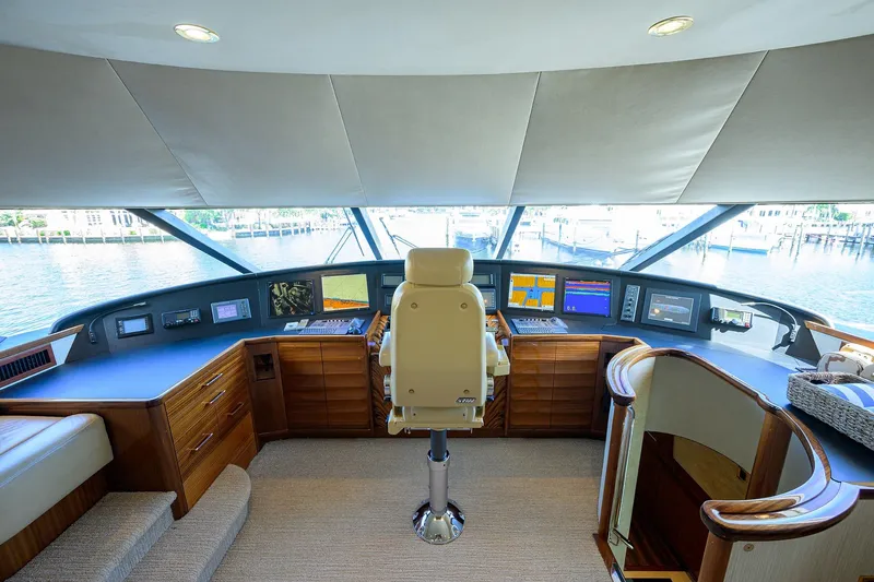Slide: The Image of Luxurious 2014 Westport 112 yacht cockpit with advanced navigation systems and plush captain's chair. - 49