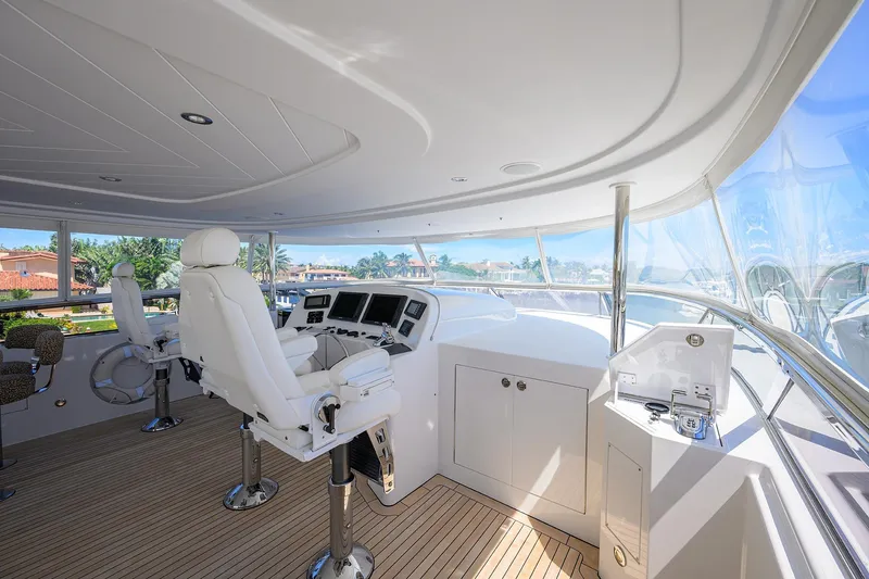 Slide: The Image of Luxurious 2014 Westport 112 yacht interior with modern helm, seating, and kitchenette. - 59