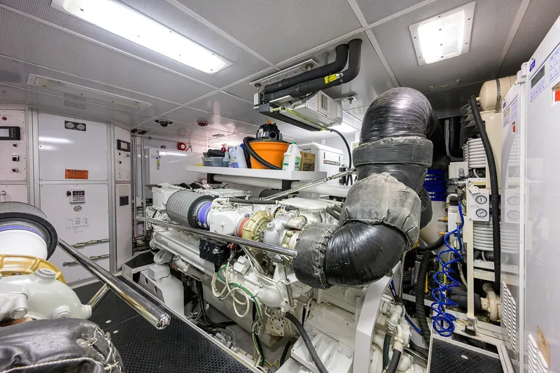 Slide: The Image of Engine room of a 2014 Westport 112 yacht, featuring dual engines and organized storage. - 67