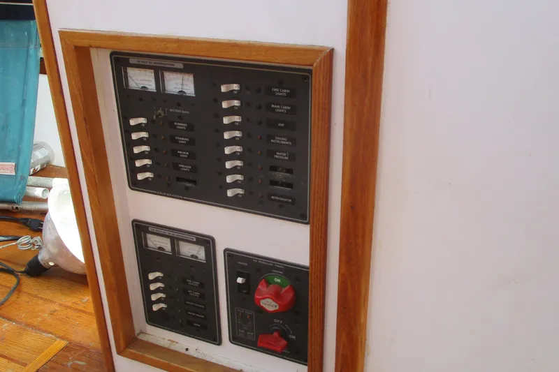 Slide: The Image of Electrical panel on 1955 Custom Gaff Rigged Ketch, featuring switches and meters. - 12