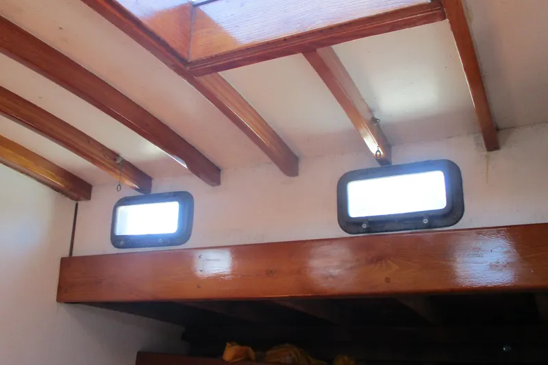 Slide: The Image of Interior of 1955 Custom Gaff Rigged Ketch with wooden beams and portholes. - 16