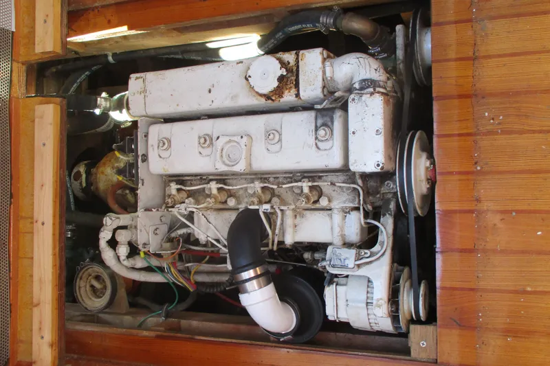 Slide: The Image of Engine of 1955 Custom Gaff Rigged Ketch, showcasing mechanical components and wooden surroundings. - 27