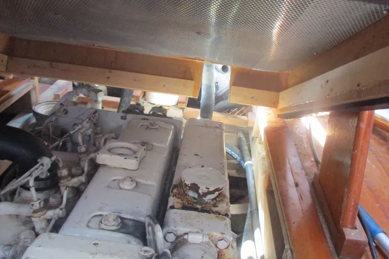 Slide: The Image of Engine compartment of 1955 Custom Gaff Rigged Ketch, showcasing mechanical components and wooden framework. - 28