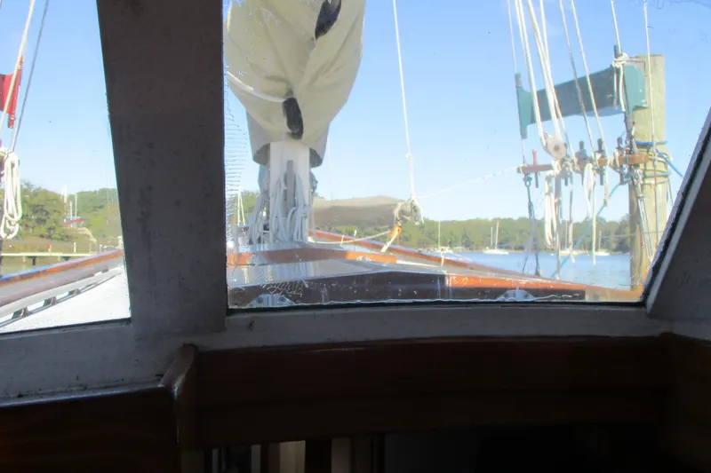 Slide: The Image of View from inside a 1955 Custom Gaff Rigged Ketch, showcasing rigging and serene waters. - 33